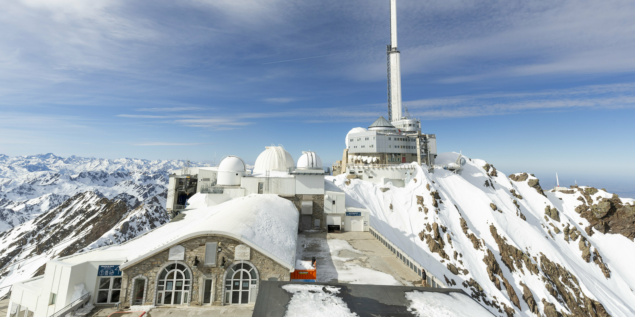 Observatórium Midi-Pyrénées, ktoré sa nachádza na zasneženom vrchole hory, predstavuje svoju rozsiahle zrekonštruovanú a rozšírenú štruktúru. Fasáda bola navrhnutá s PREFALZ vo farbe P.10 čisto biela, ideálna do extrémnych vysokohorských podmienok. Obrázok ukazuje niekoľko kupol a hlavnú budovu, ktorá sa majestátne týči oproti modrej oblohe a zasnežené Pyreneje. Odolnosť voči poveternostným vplyvom, odolnosť proti korózii a nenáročná údržba ľahkého hliníka prepravovaného vrtuľníkom z neho urobili perfektnú voľbu. Stavebné práce trvali viac ako tri roky, pretože sa mohli realizovať len v letných mesiacoch