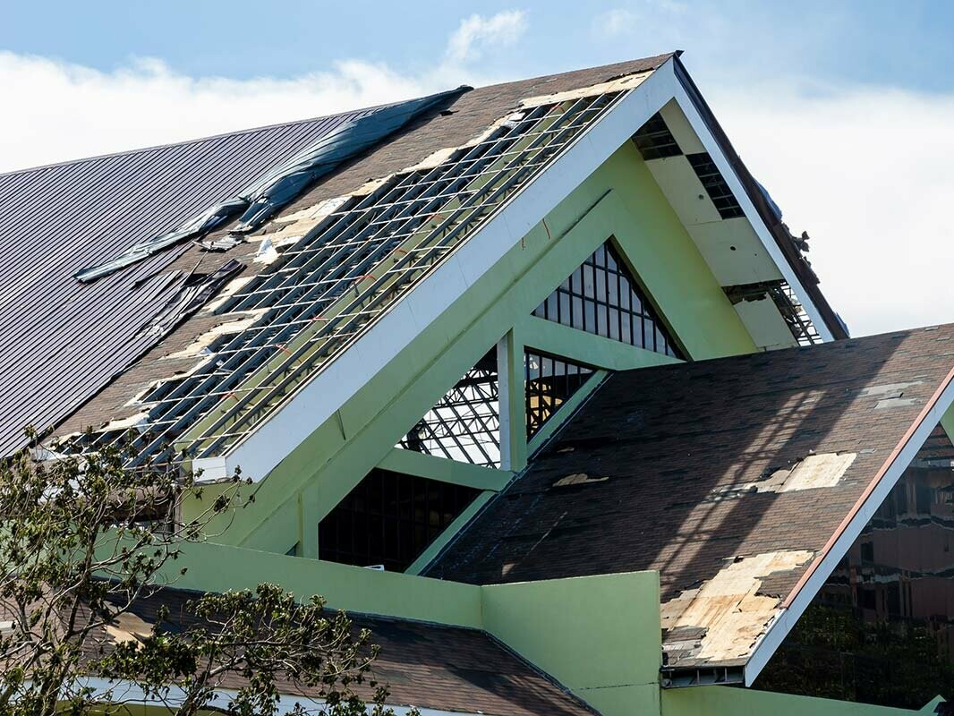 Silne poškodená, čiastočne strhnutá strecha po silných búrkach