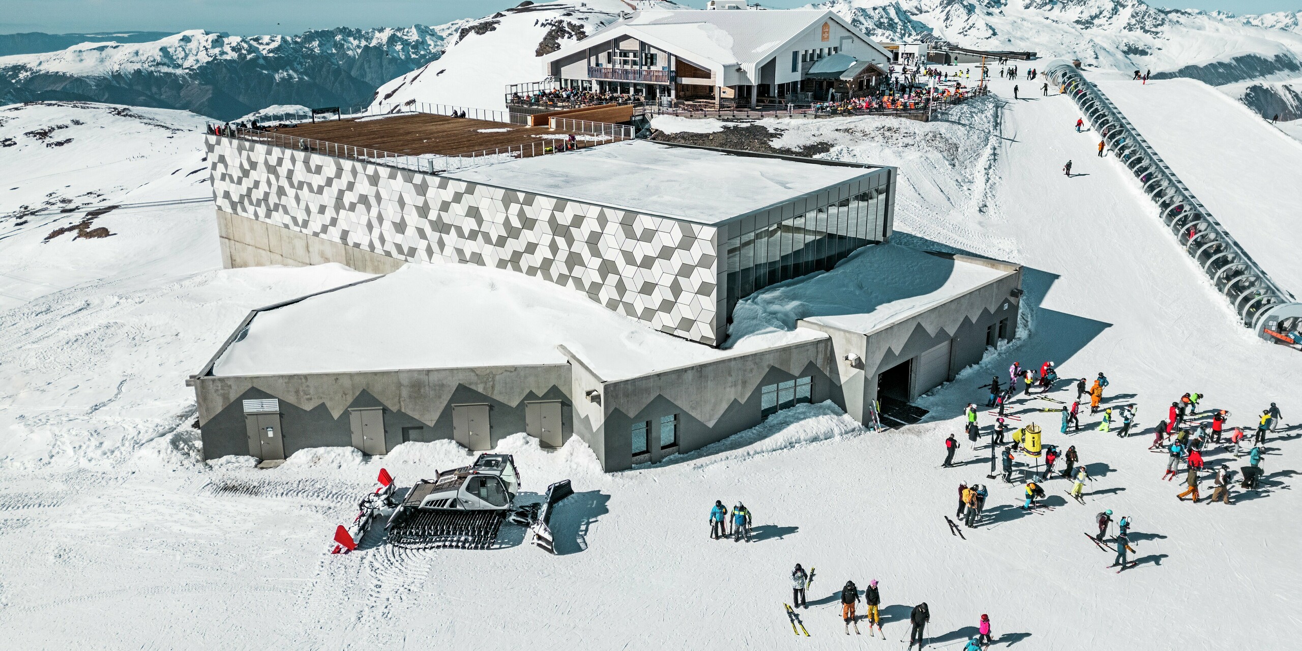 Pôsobivá horská stanica lanovky v Les Deux Alpes harmonicky zapadá do alpskej krajiny vďaka modernej fasáde z hliníkových kompozitných panelov PREFABOND. Výrazný geometrický kosoštvorcový vzor v odtieňoch bielej a sivej harmonicky zapadá do zasneženého okolia a vytvára veľkolepý vizuálny efekt. Trvácna fasáda odolná voči poveternostným vplyvom zaručuje nielen estetickú dokonalosť, ale aj ochranu pred extrémnymi poveternostnými podmienkami vo vysokých horách.