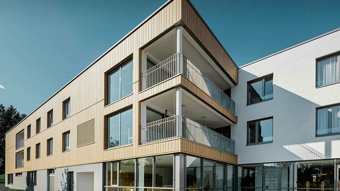Viacpodlažný bytový dom s alternatívou vzhľadu dreva – panely v pieskovohnedej farbe